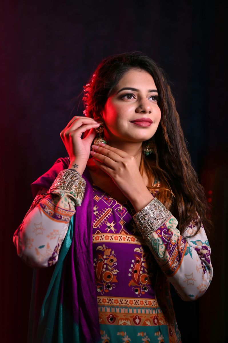 Portrait of a woman in colorful Indian attire, showcasing elegance and grace.